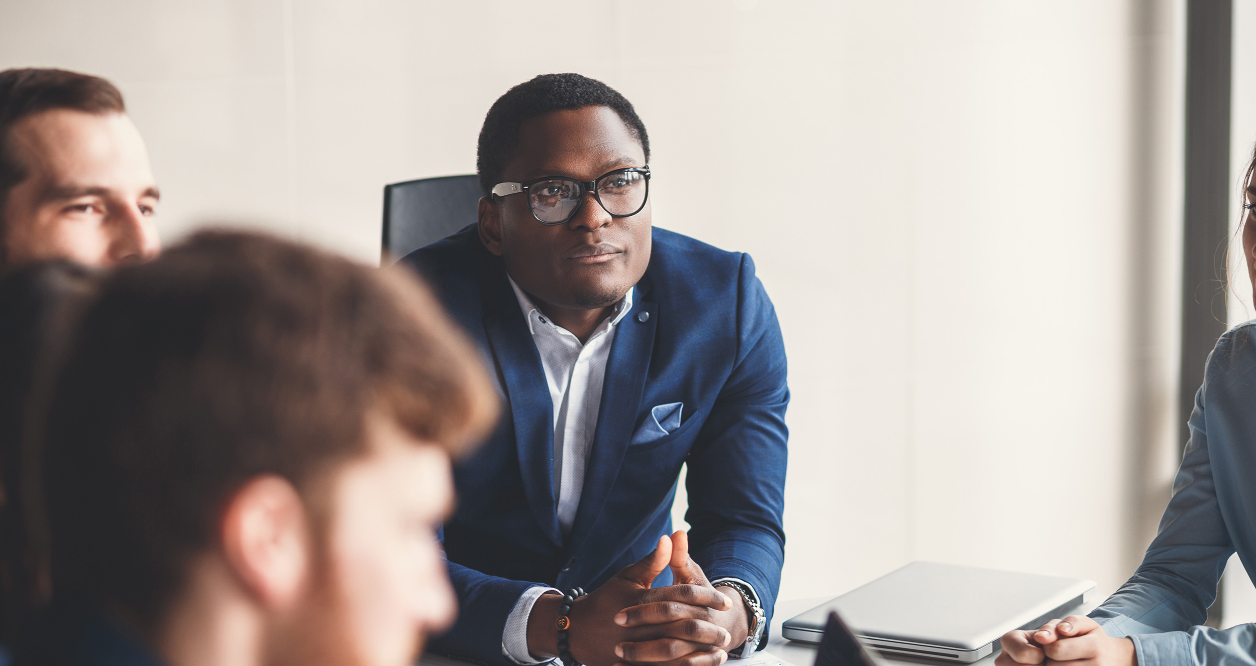 Businessman presenting to colleagues at a meeting