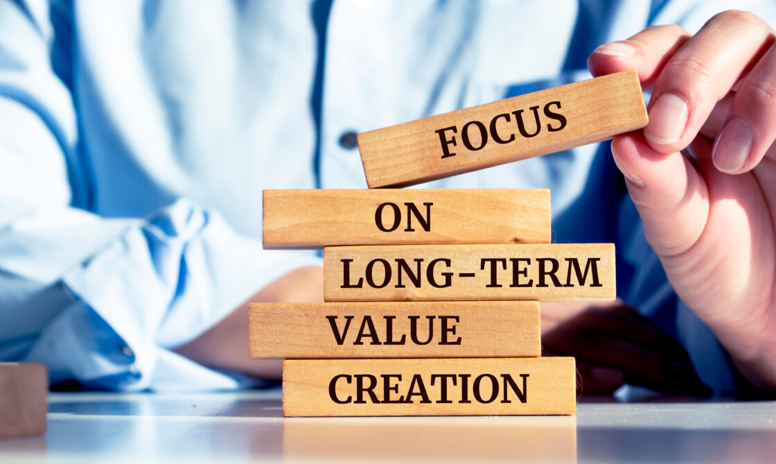 Close up on businessman holding a wooden block with a 