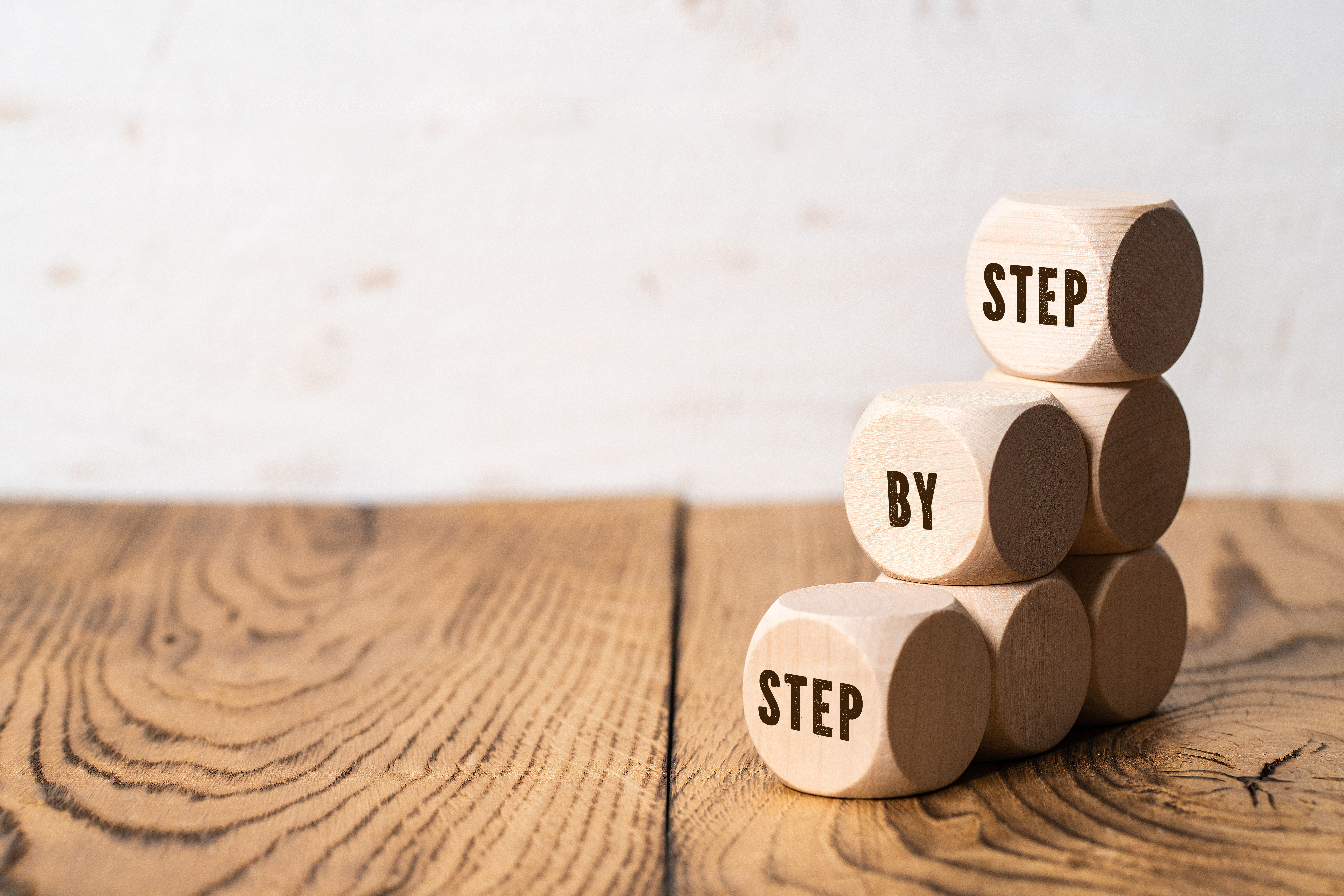 Wood blocks forming steps that read step by step on each