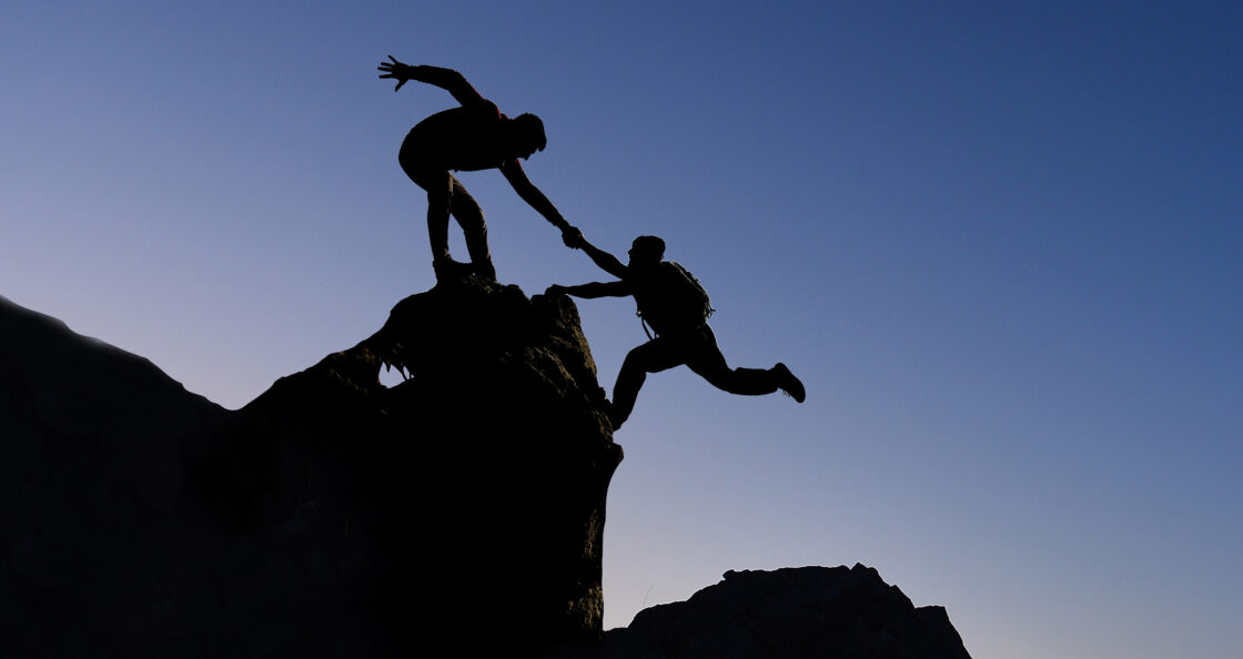 Mountain climbers helping hand