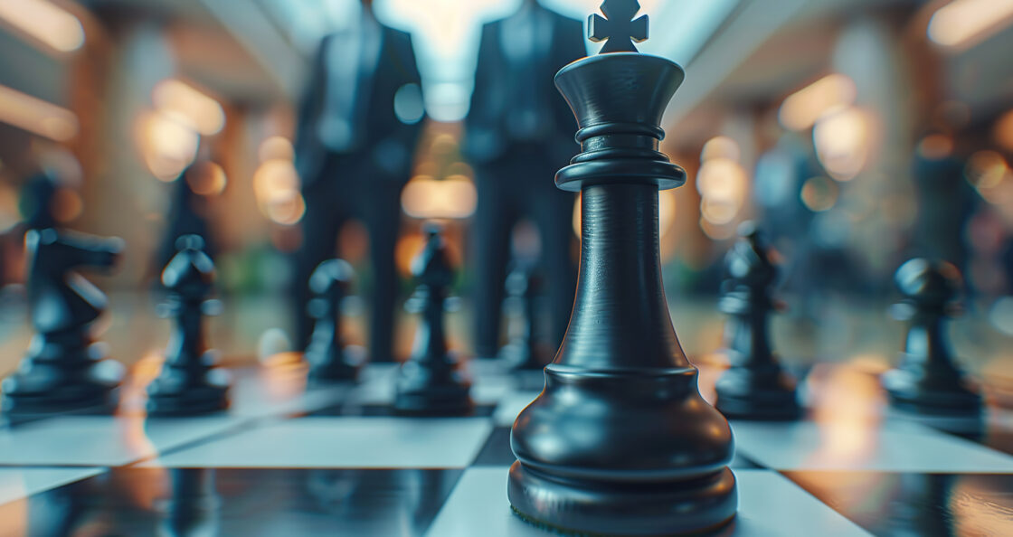 Chess board with two sales reps standing in the background
