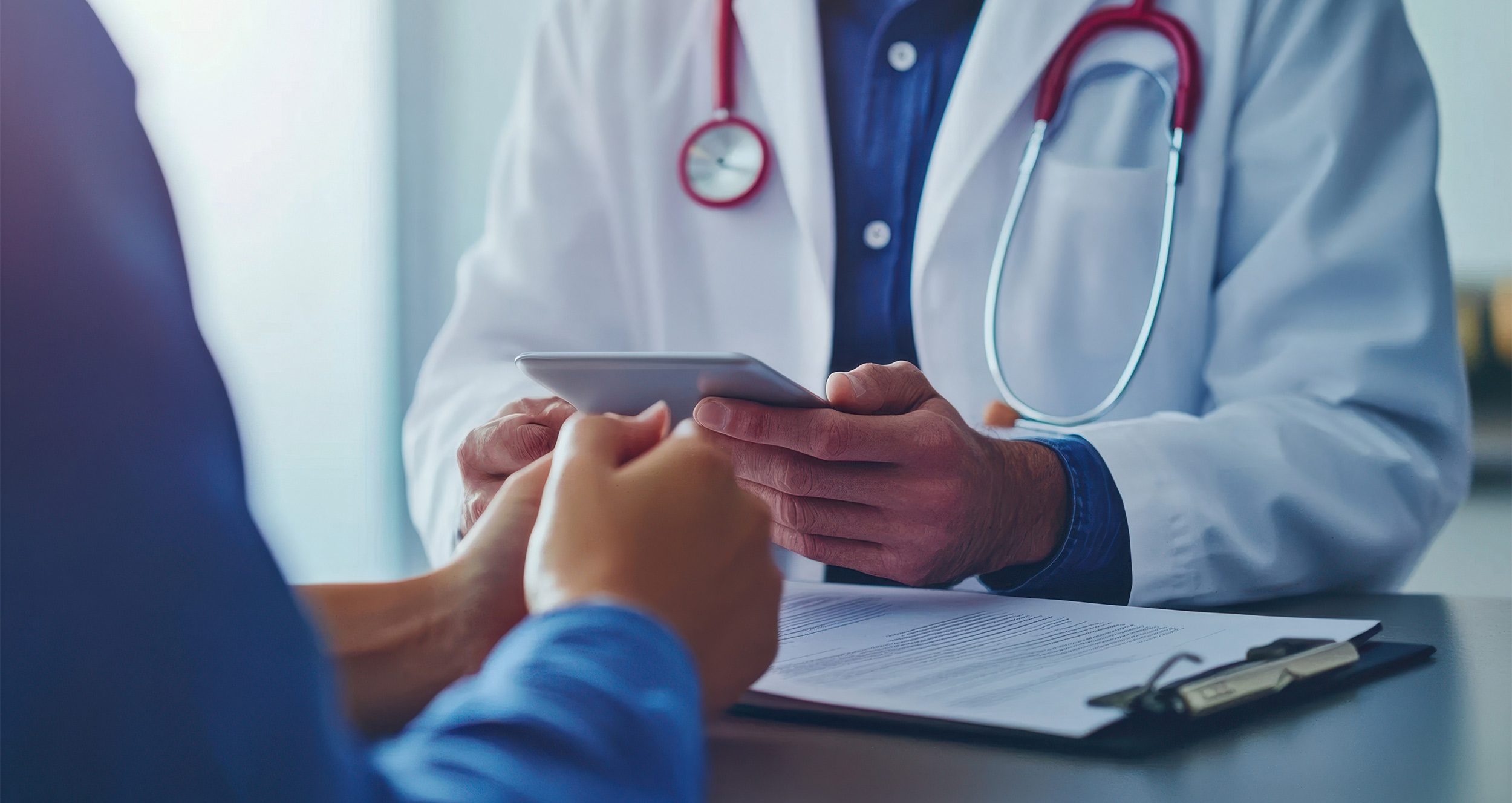 healthcare professional and pharma rep meeting at table