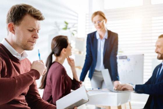 disengaged employee working away from team