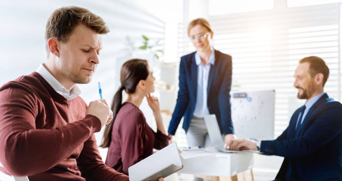 disengaged employee working away from team