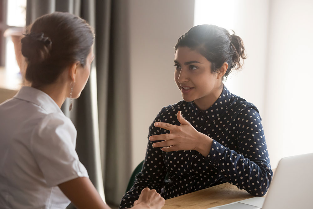 sales leader speaking with teammate